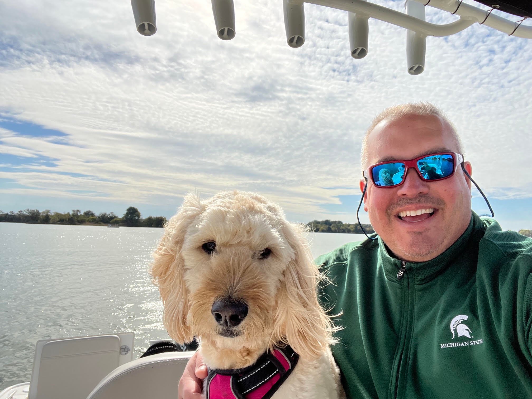 Brett and his dog the Pursuit Boats OS 355 Offshore