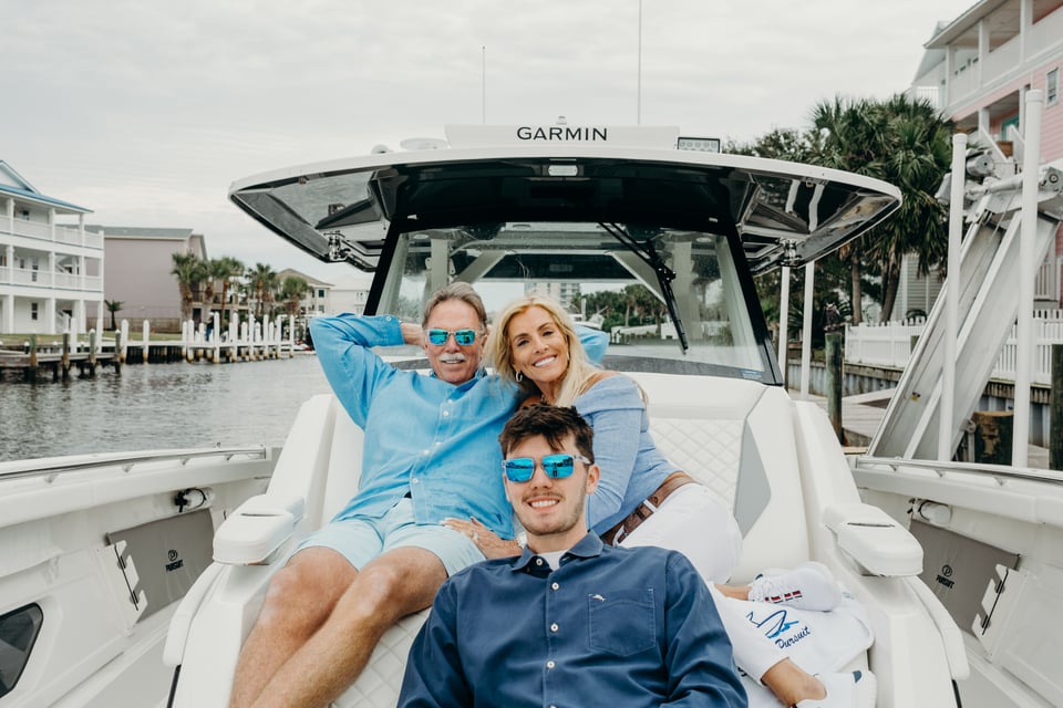 Happy family aboard their Pursuit S 428