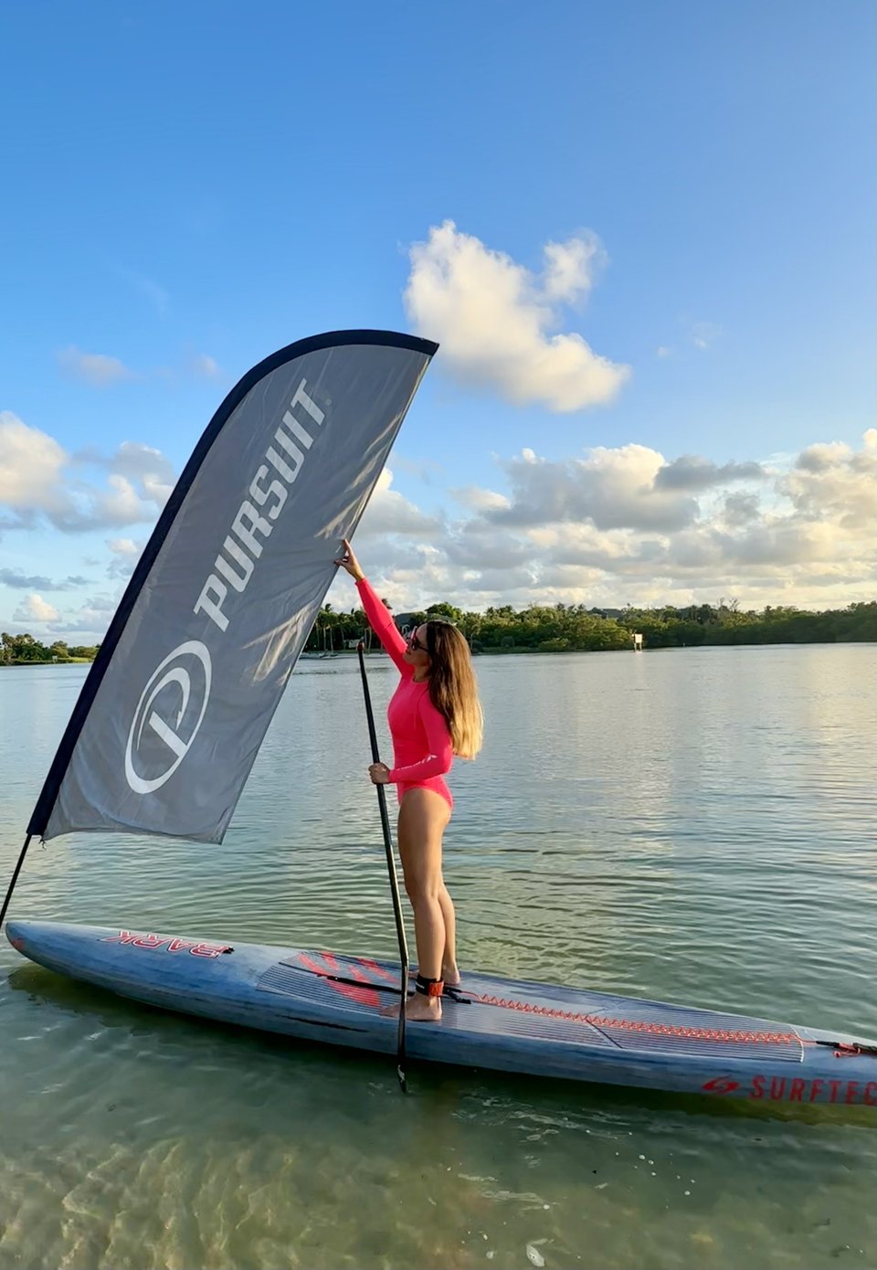 Liubov on paddle board with Pursuit Flag