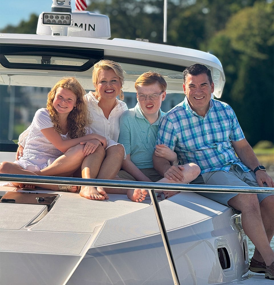 The Millers sit on the bow of their Pursuit OS 355.