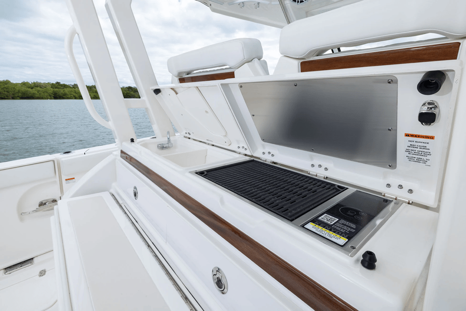 Entertainment center with grill and sink open on Pursuit S 328 Center Console.