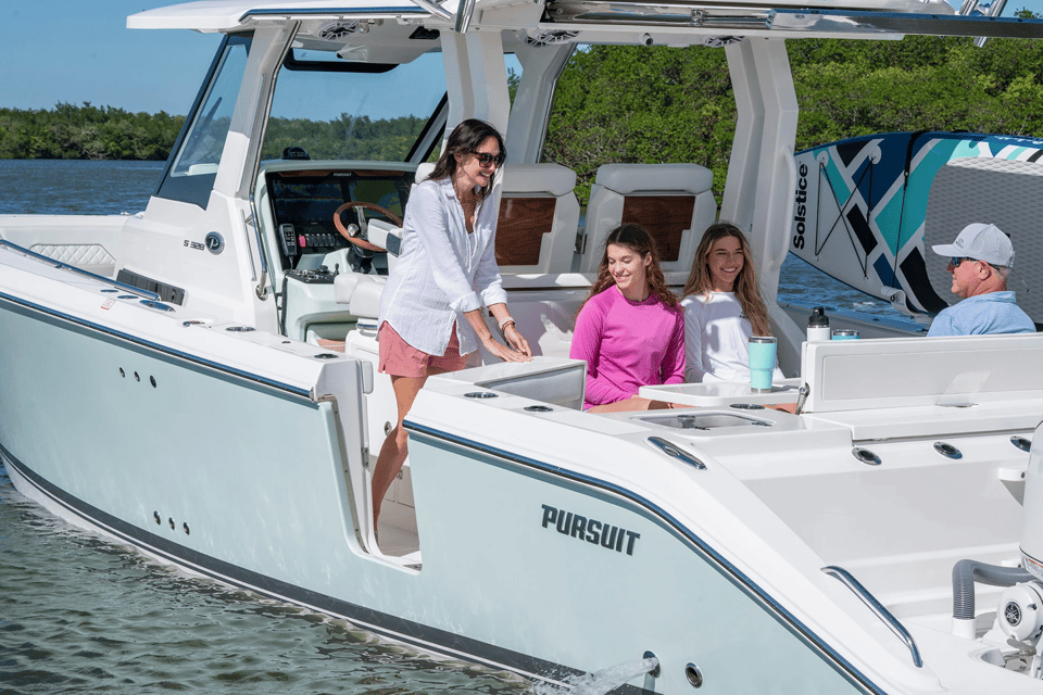 Woman opens molded hull side boarding door on the port side