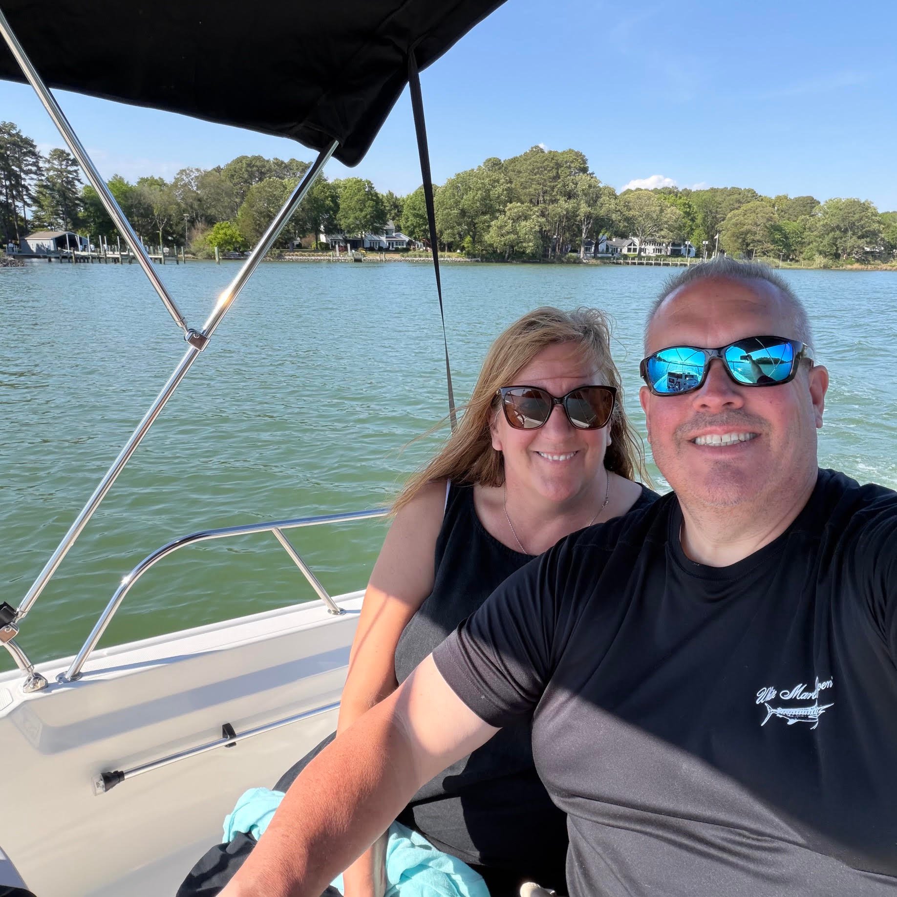 Pursuit and Molly Kate on their Pursuit cabin cruiser OS 355