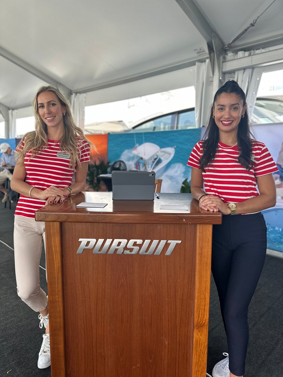 Greeters at Pursuit Booth at FLIBS