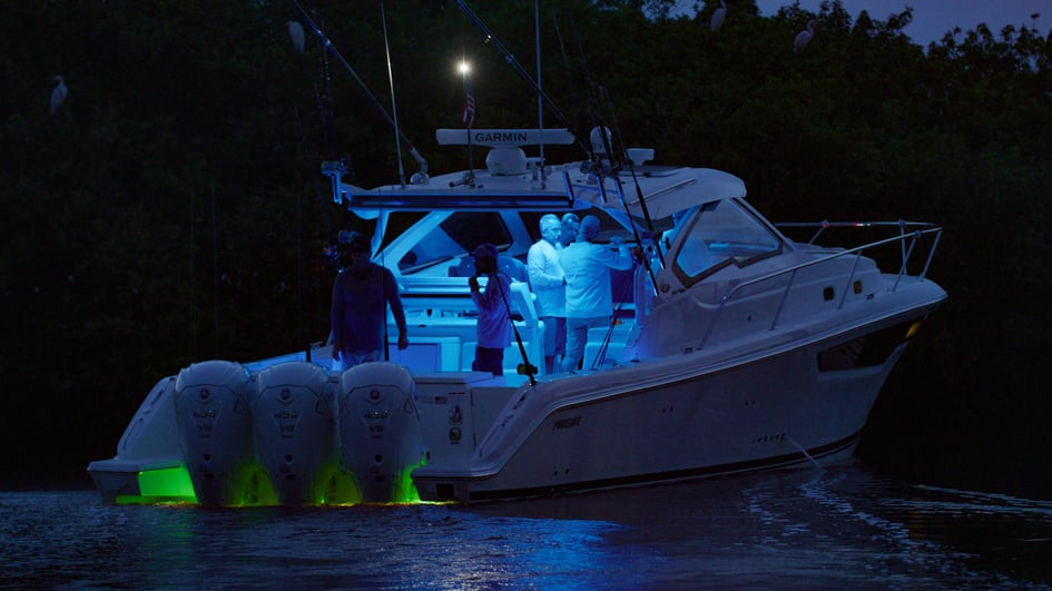 Pursuit boat at night with navigation lights