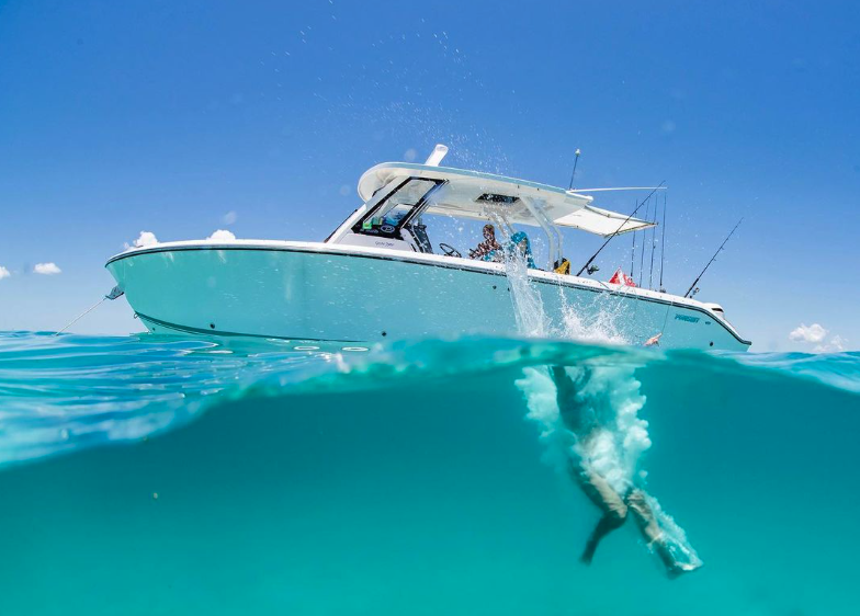 Pursuit Boat with family jumping into the ocean