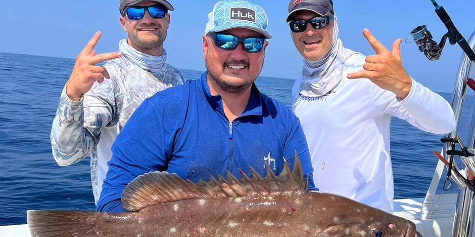 Stanly Watts on his Pursuit Boat with a Grouper.