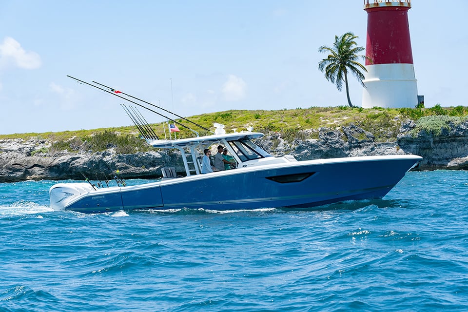 Profile view of Gulf Stream Blue S 428 Sport center console boat running right with quad Yamaha outboard engines.