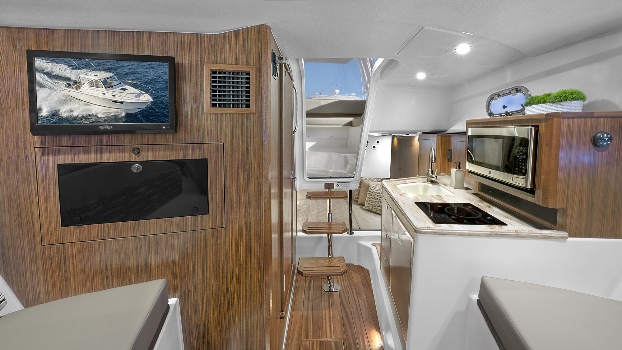 OS 325 offshore boat cabin galley with Corian countertops and storage.