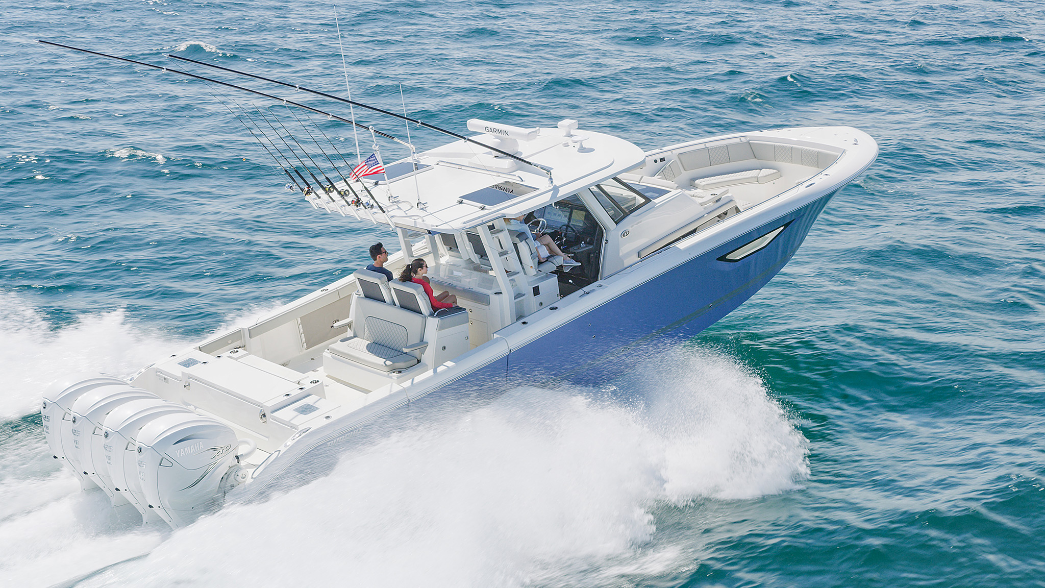 Aerial profile view of Gulf Stream Blue S 428 Sport boat running right with hull side window and second row of innovative retractable seats.
