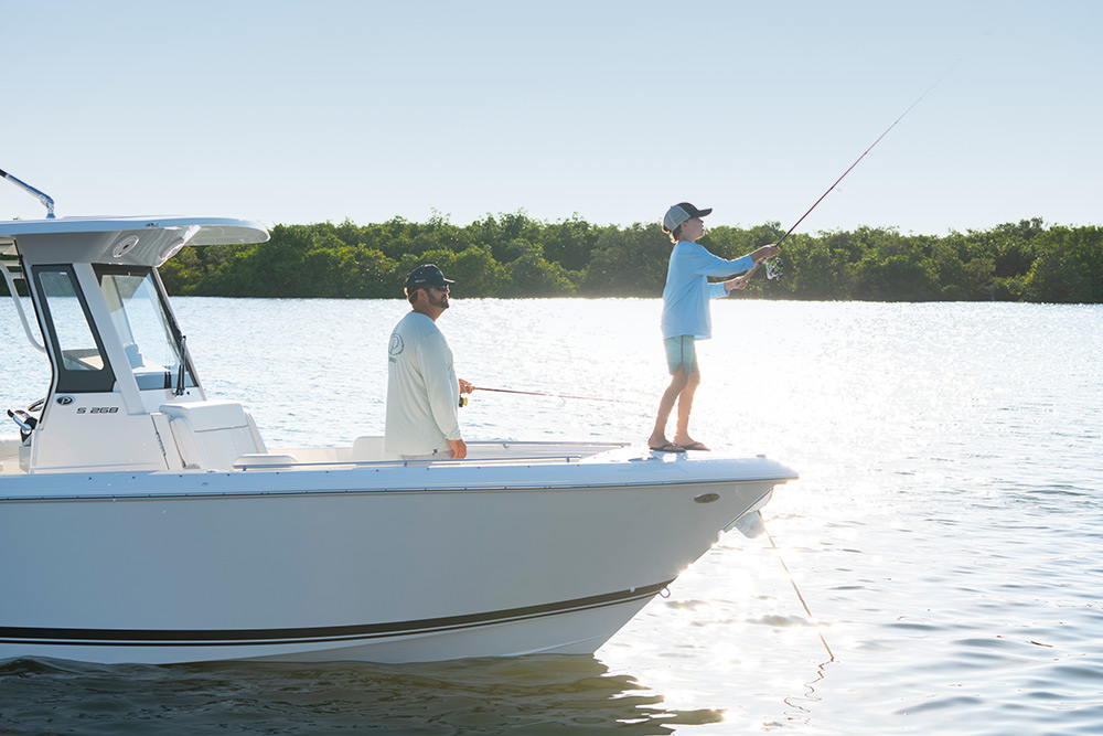 Father and son fishing from bow of Pursuit S 268.